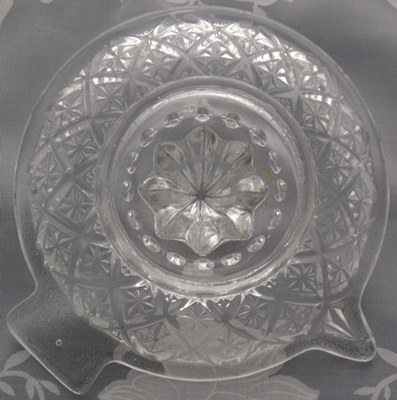 Bottom view of a clear glass juicer with diamond pattern