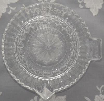 Top view of a Japanese clear glass saucer shape juicer