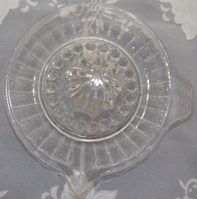 Top view of a vertical lines of small pyramids on a 1 piece clear glass juicer