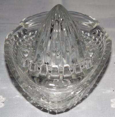 Showing the seed dam on a clear glass egg shape juicer 