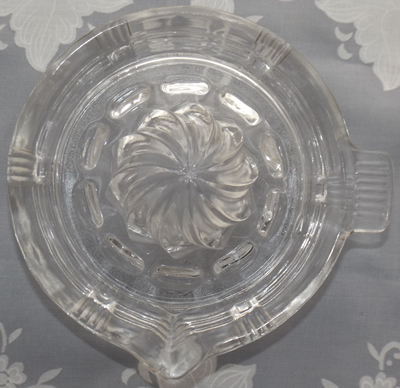 Top view of a Hazel Atlas 'crisscross' saucer shape clear glass juicer
