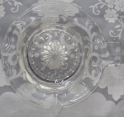 Top view of a clear glass stylised tree pattern juicer