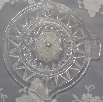 Top view of a Triangular patterned bowl clear glass juicer