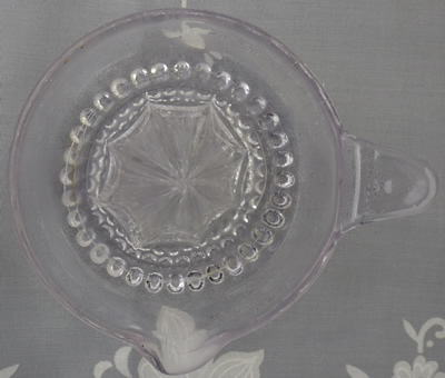 Clear glass with hobnail base juicer top view