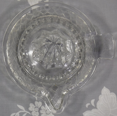 Diamond pattern clear glass saucer juicer top view