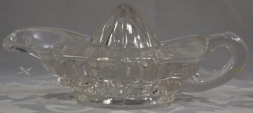 Small clear glass Aladdin lamp juicer with diamond pattern side view