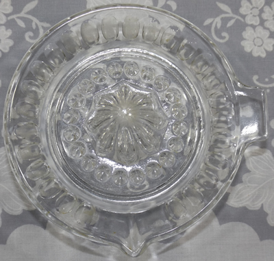Top view of 26 panel saucer shape clear glass juicer