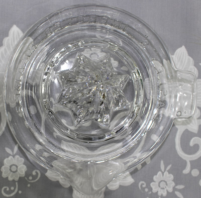 Showing Easley's Improved Reamer saucer shape clear glass juicer top view