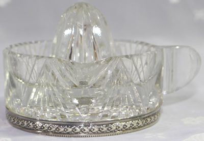 Side view of silver rim on base of a French crystal juicer