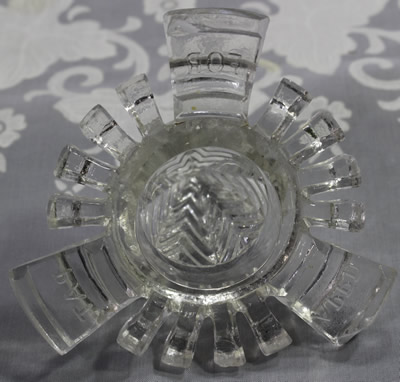Bottom view showing the embossed writing on a C. H. Read clear glass 'Juice Extractor' 