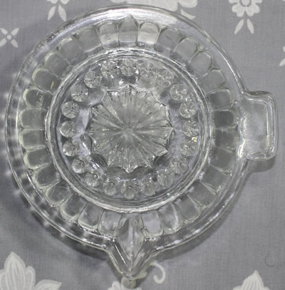 Top view of a 29 convex panel clear glass offset tab handle juicer