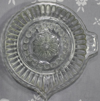 Top view of a 44 convex panel clear glass offset tab handle juicer
