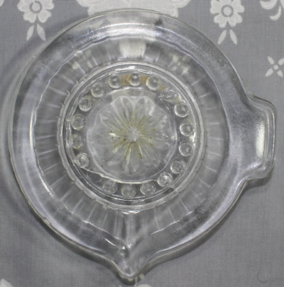 Top view of a 35 concave panel clear glass offset tab handle juicer