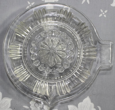 Top view of a VLG clear glass offset tab handle juicer