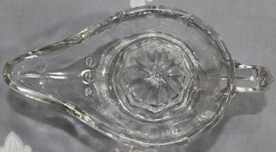 Top view of a flat handle Alladin's lamp clear glass juicer