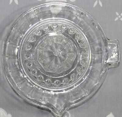 Top view of a 20 panel clear glass sauce shape juicer