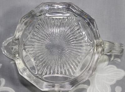 The base of the jug for a Westmoreland Specialty Co. clear glass 'Baby's Orange' juicer