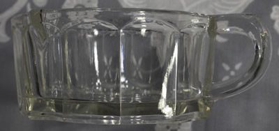 The front of a 2 piece juicer with an offset loop handle and 12 rectangular panels juicer