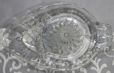 Top view of a seed dam clear glass egg shape juicer