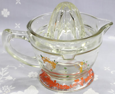 Back view of a U.S. Glass Company Clear - red base Decorated juicer