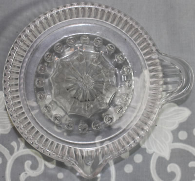 Top view of a small vertical flute clear glass juicer