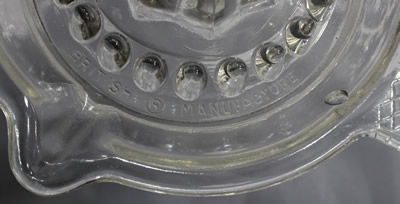 The embossed BRITISH ® MANUFACTURE from pouring spout to the tab handle 