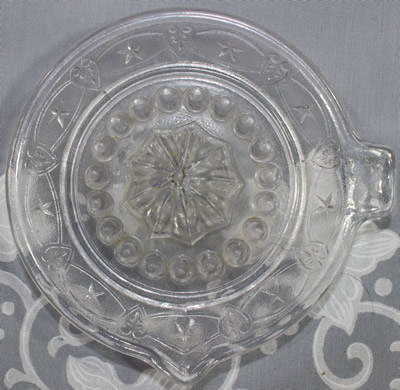 Top view of a stars in loops clear glass juicer