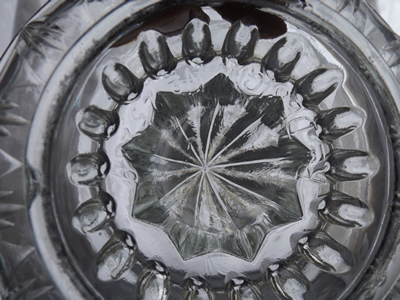 The embossing Rd DESIGN No 25239 on a clear glass saucer juicer 