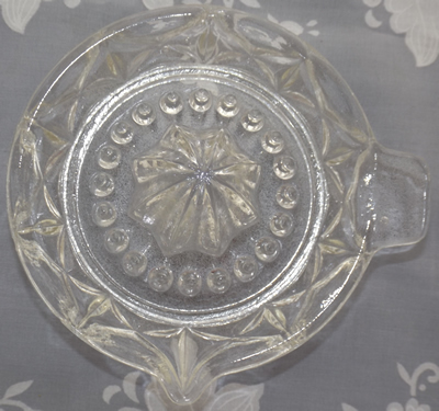 Clear glass saucer juicer top view