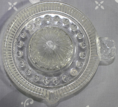 Top view of small clear glass saucer juicer 