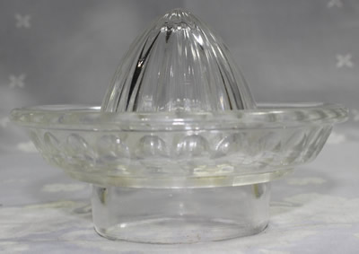 Side view of a Elliptical panels on a clear glass juicer top