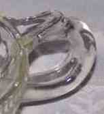 The handle on a Anchor Hocking Glass Company clear glass ribbed juicer