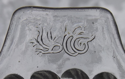 The tab handle of a dragon on tab handle sloping flutes pattern clear glass juicer