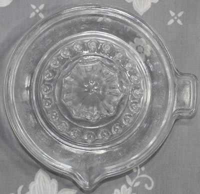 The top view of a plain "FRANCE REIMS" clear glass juicer