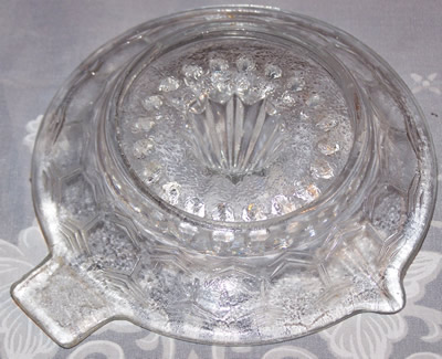 Bottom view of a hexagonal panels clear glass saucer juicer