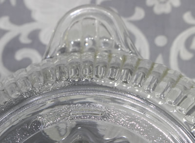 Showing the speckled base and feet on a large Anchor Hocking clear glass juicer