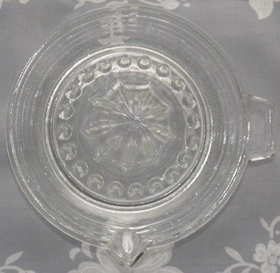 Top view of a banded bowl clear glass juicer 