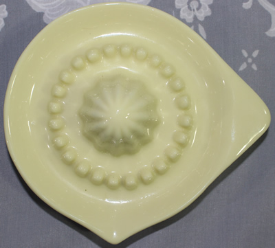 Top view of small custard ceramic (or glass) saucer juicerer juicer
