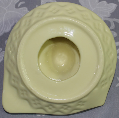 Bottom view of small custard ceramic (or glass) saucer juicer