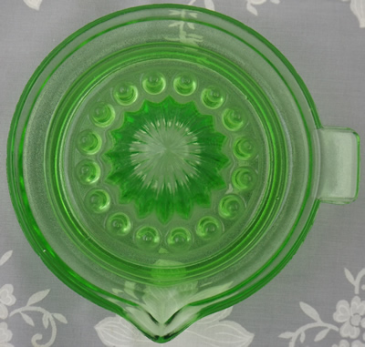 Top view of a green Jeannette Glass saucer juicer