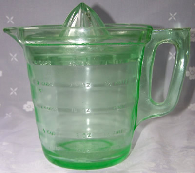 A sideview of a U.S. Glass Green glass snowflake 4 cup juicer 