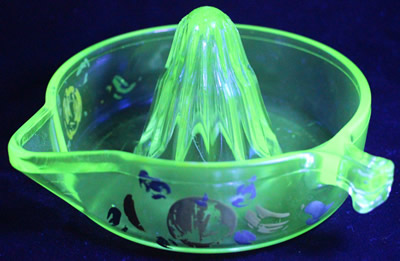 A painted Tufglas glass juicer under UV light