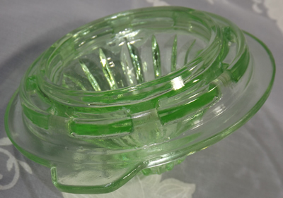 Showing the bottom of the reamer for a 1 pint Crown Crystal green uranium glass juicer jug set