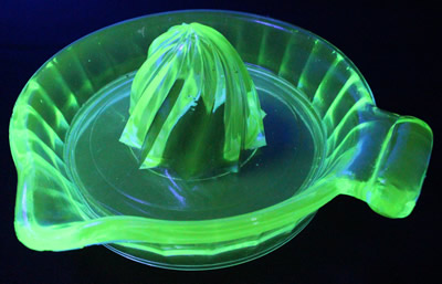 Top view of a clockwise spiral 1 piece pale green glass juicer