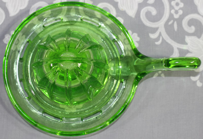 Top view of a Easy Squeeze green glass juicer fitting
