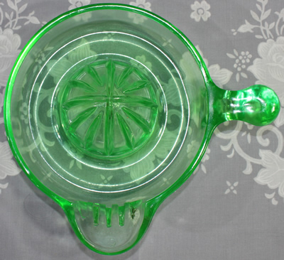 Top view of an offset tear drop handle green glass US Glass Co. juicer