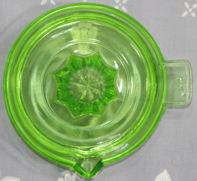 Top view of a Federal Glass green glass offset tab handle juicer