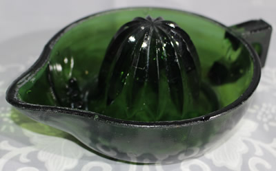 Alternate view of a square handle emerald green glass juicer