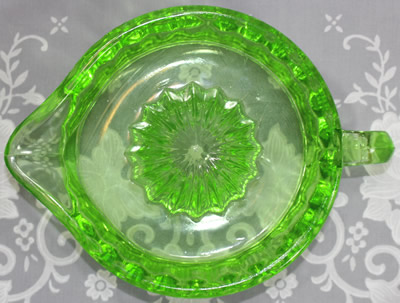 Top view of a Pacific Coast Glass Works green glass unembossed juicer