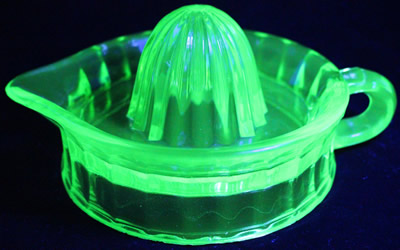 Pacific Coast Glass Works green glass unembossed juicer under UV light